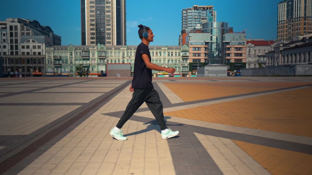 ⁣mixkit-young-man-walking-listening-to-music-from-his-headphones-4855-full-hd